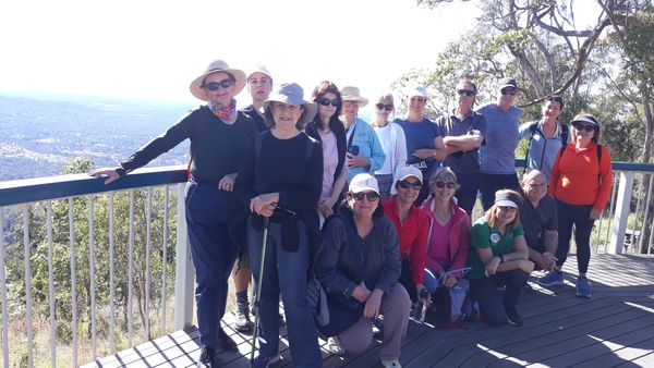 A group of walkers stand for a photo at the top of Jolly's Lookout
